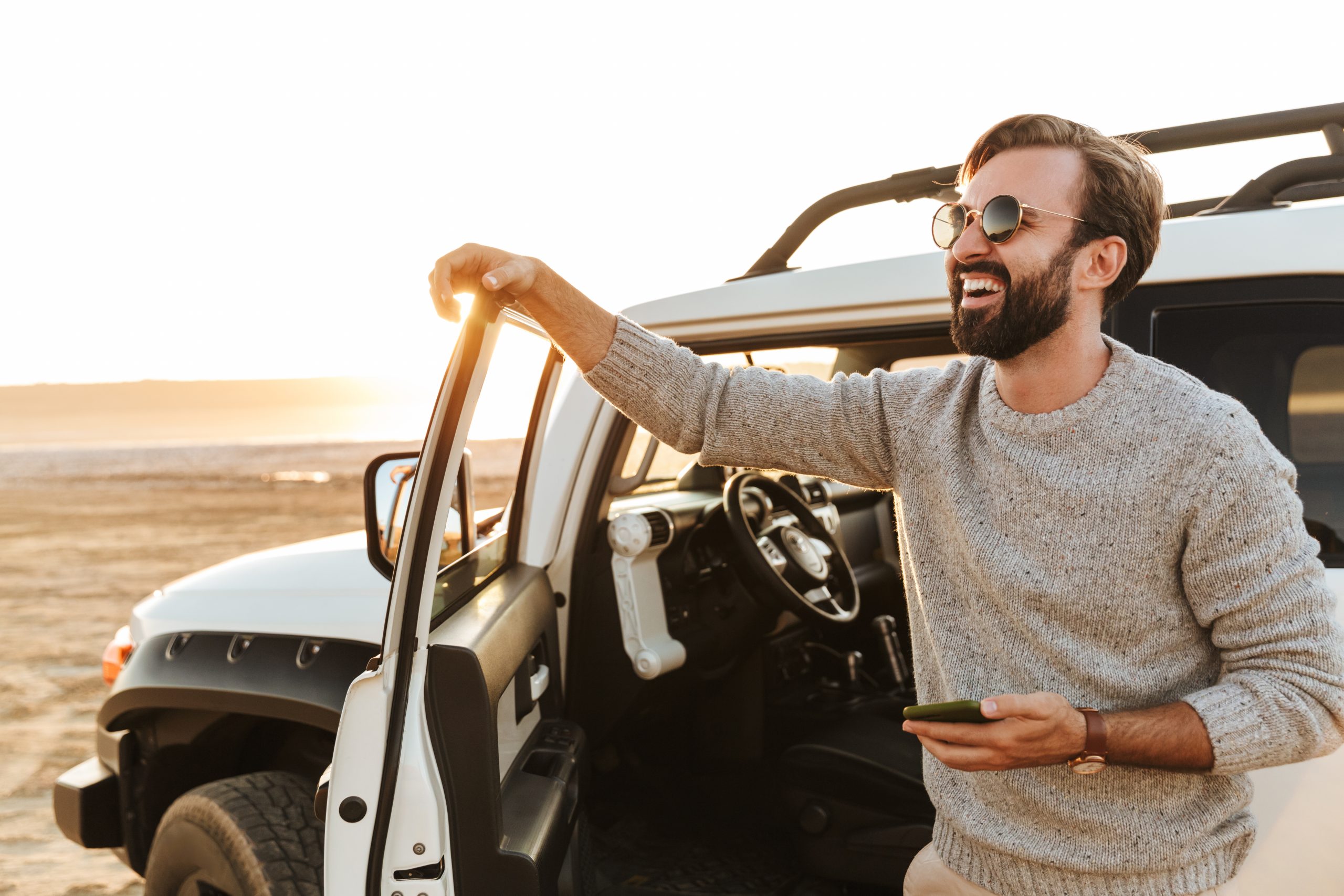 photo of a man and a car in a desert