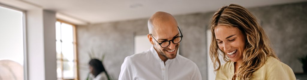 two smiling people talking about social media support