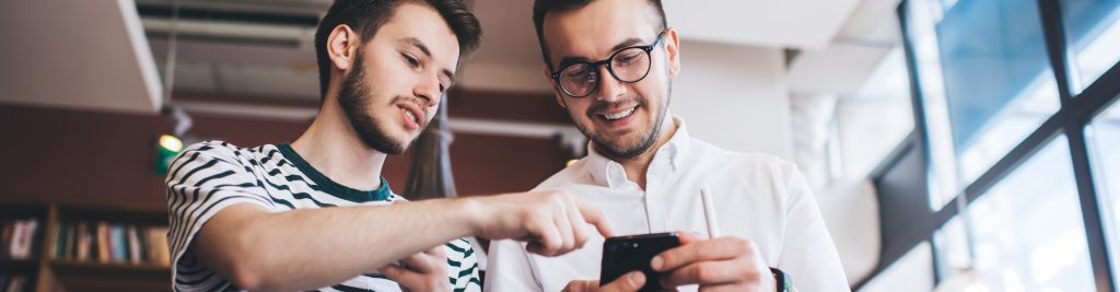 2 men looking at a phone